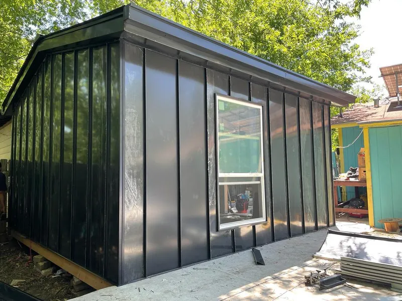 Black standing seam metal wall panels for Roof Inspection in Steger