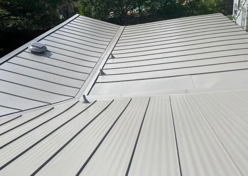 Solar attic fan installed on a metal roof for Roof Ventilation in Steger